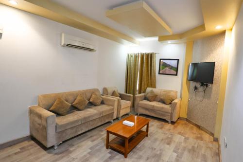 a living room with a couch and a table at Muscat-Seeb 1BHK comfort apartment in Seeb
