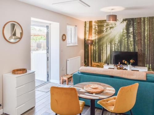 a living room with a couch and a table at Elm - Uk50463 in Alvington