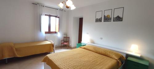 a bedroom with two beds and a window at Tana di Zia Nature, Yourself, Love in Viggianello