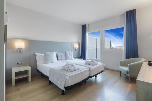 a hotel room with two beds and a window at Augusta Barcelona Vallès in Granollers