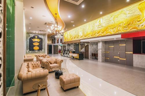 a lobby with couches and chairs in a building at Gallery Design - SHA Extra Plus in Si Sa Ket