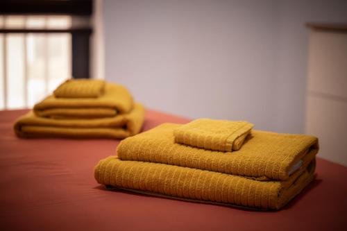 two yellow towels sitting on top of a bed at Modern SeaView Luxury Apartment in St. Paul's Bay
