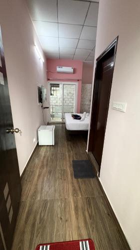 a hallway with a room with a bed and a door at White Rabbit Rooms in Bangalore