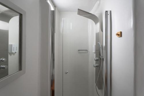 a shower in a bathroom with a mirror at WHITE W4 new studio in Naousa in Naousa