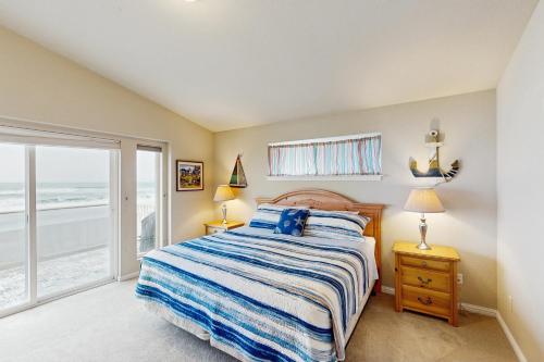 a bedroom with a bed with a view of the ocean at Ocean Lover's Landing in Gold Beach
