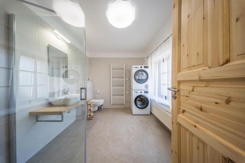 a bathroom with a sink and a washing machine at Chalupa Pod Starú horú in Bohuslavice