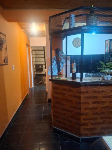 a fish tank in a kitchen with a counter at Posada Ruta 65 in General Fernández Oro