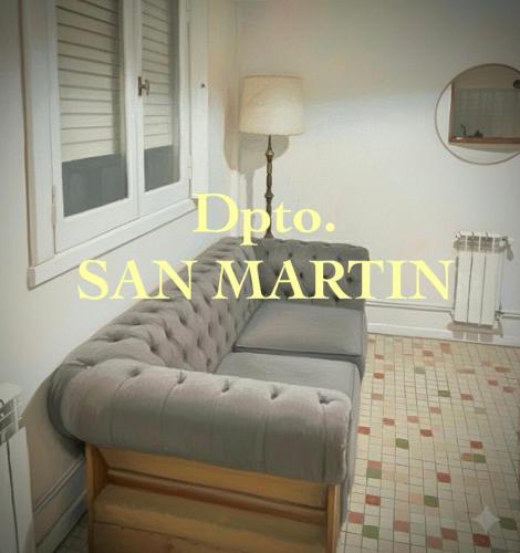 a couch in a living room with the words dino san marino at Dpto SAN MARTIN in Azul