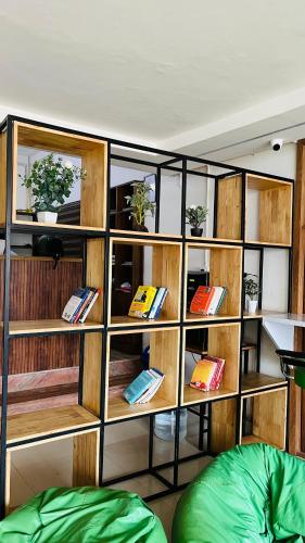 a book shelf filled with books in a room at LF Easybeds in Kozhikode