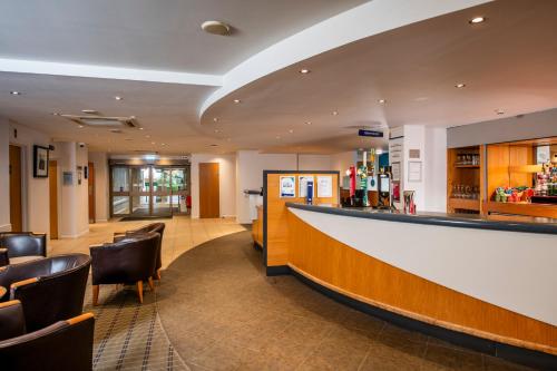 a bar in a hotel with chairs and a counter at Holiday Inn Express Inverness by IHG in Inverness
