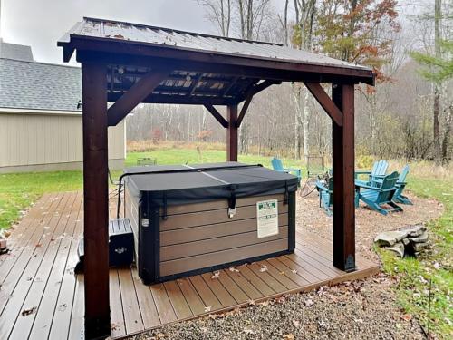 a wooden deck with a gazebo on top of it at Buzzy Bee Lodge in McHenry