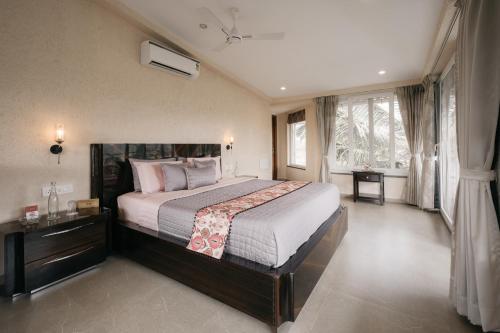 ein Schlafzimmer mit einem großen Bett in einem Zimmer in der Unterkunft amã Stays & Trails - Assa 360 , Goa in Assagao