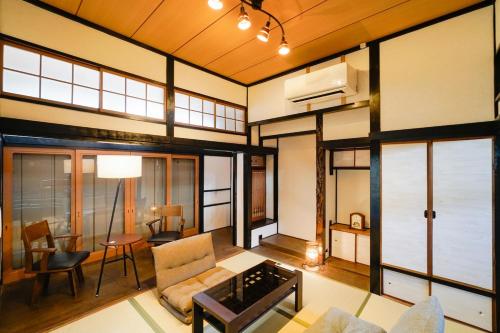 a living room with a couch and a table at 灯りの宿 in Kitakyushu