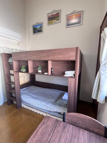 a bed in a room with a wooden bunk bed at FukuStay CCB1-201 福居 地下鉄駅徒歩2分 in Fukuoka