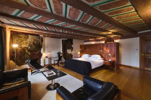 a hotel room with a bed and a couch at Widder Hotel - Zurichs Luxury Hideaway in Zurich