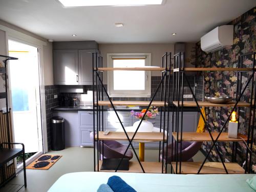a kitchen with wooden shelves in a room at Sfeervol guesthouse, privé tuin en free parking in Rotterdam