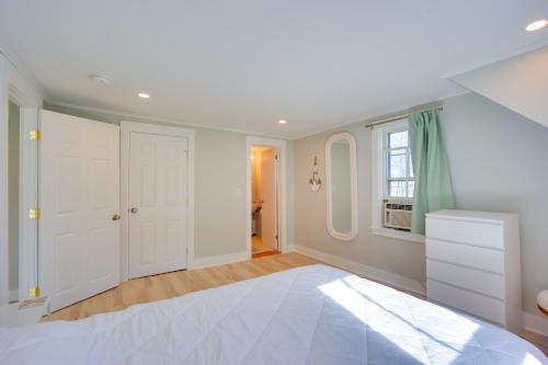 a white bedroom with a bed and a window at Lake-View Spofford Apartment w/ Shared Dock! in Spofford