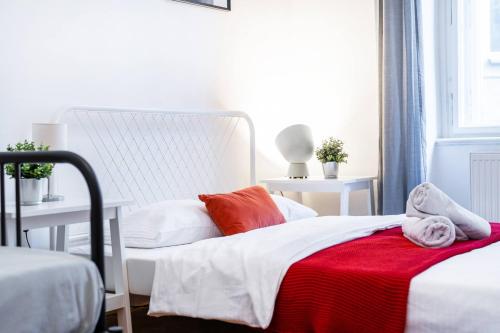 a bedroom with a bed with a red blanket on it at 2BDR Old Town Square Apartments w Fast Wi-Fi in Prague