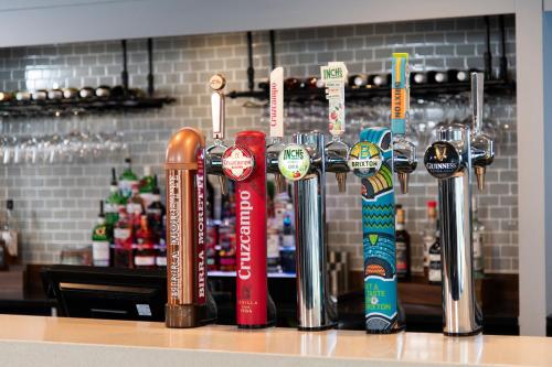 a row of trophies on a counter in a bar at Holiday Inn Express - Glasgow Airport by IHG in Paisley