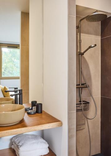 a bathroom with a sink and a shower at Kaze Océan, The Originals Relais in Cap-Ferret