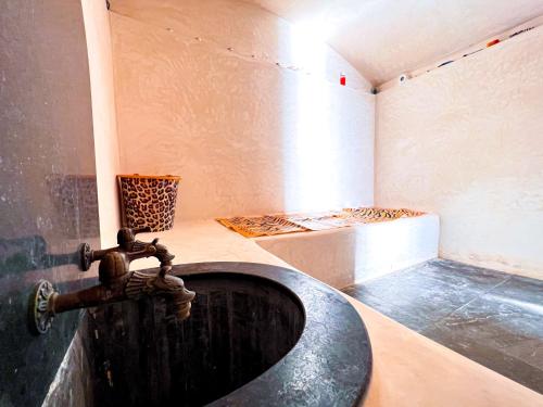 a bathroom with a sink in a room at Villa Sunset Moulay in Beni Balla