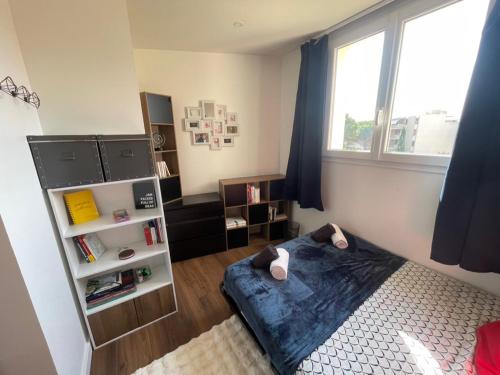 a bedroom with a bed and a window at Elegant apartment Saint-Raphaël in La Celle-sous-Gouzon