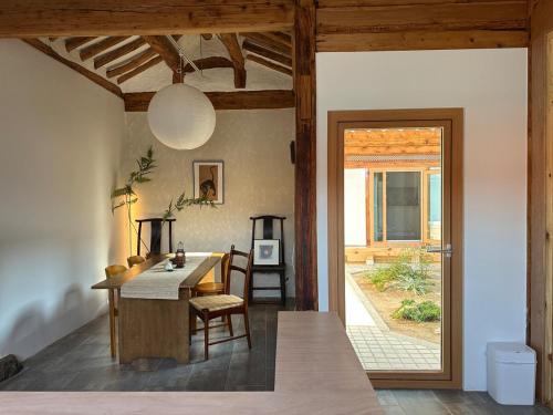 a kitchen with a table and a dining room at seoul hanok stay moonee in Seoul