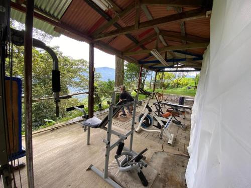 a man working out in a gym with exercise bikes at Finca Panoramica in Barbosa