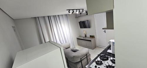 a small living room with a chair and a table at RG Kitnet01 in Curitiba