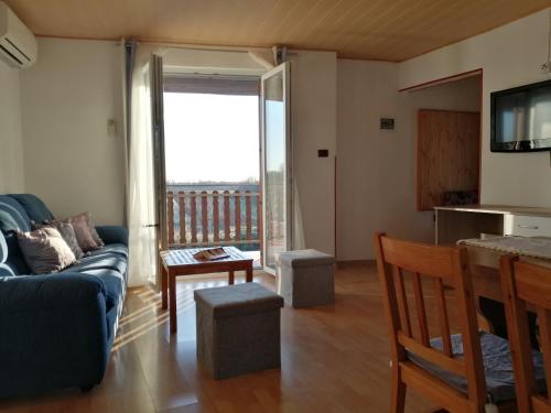 a living room with a couch and a balcony at App Isabel in Žminj