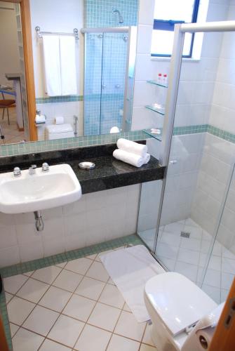 a bathroom with a sink and a toilet at Vila da Serra Differential in Nova Lima