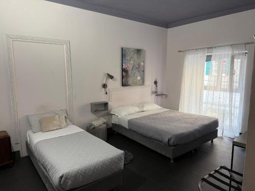 Ένα ή περισσότερα κρεβάτια σε δωμάτιο στο Holidays Rooms Rattazzi