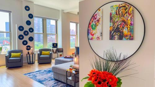 a living room with a mirror on the wall at Downtown Cleveland- Steps to Sports & Events condo in Cleveland