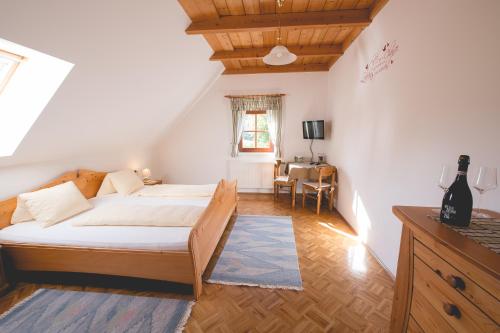Un dormitorio con una cama y una mesa dentro. en Weingut Schwarzl, en Ratsch an der Weinstraße