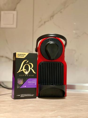a box and a black and red object next to a box at Chari's Apartment in Tríkala