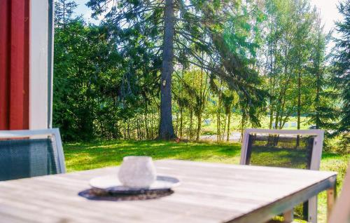 a table with a cup sitting on top of it at Amazing Home In Bjärtrå With Sauna in Bjärtrå