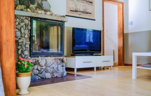 a living room with a tv and a fish tank at Amazing Home In Bjärtrå With Sauna in Bjärtrå