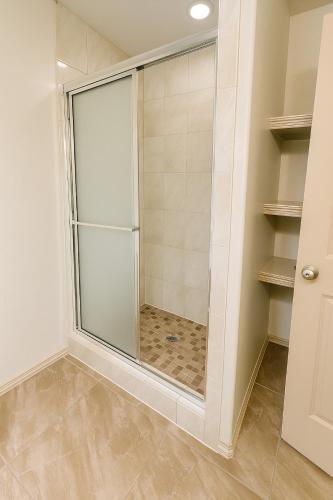 a shower with a glass door in a bathroom at Hummingbird Haven 1 in Pharr