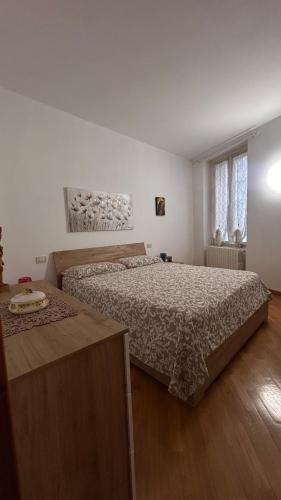 a bedroom with a large bed and a wooden floor at Alida in Salò