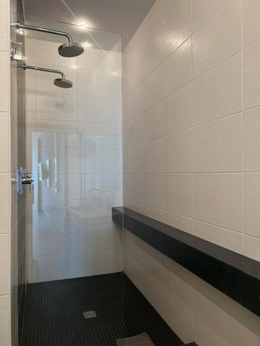 a bathroom with a shower and a sink at Lounge 04 in Norderney