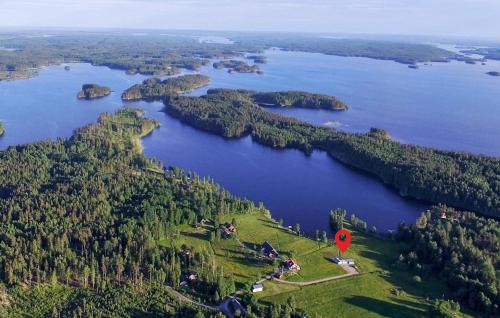 an island in a lake with a red sign on it at 3 Bedroom Beautiful Home In Årjäng in Årjäng