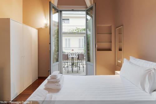 a bedroom with a white bed and a table at Brera Apartments in Duomo in Milan
