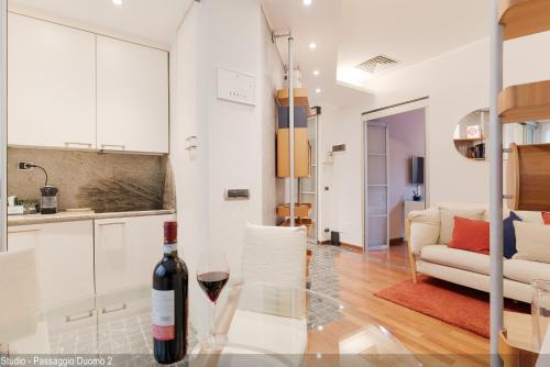 a bottle of wine sitting on a glass table in a living room at Brera Apartments in Duomo in Milan