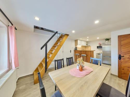 a dining room with a table and a staircase at Holiday Home Leisure Lounge & Pool by Interhome in Kvasiny
