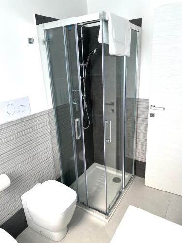 a bathroom with a shower and a toilet at Levante Apartments in Torrenova