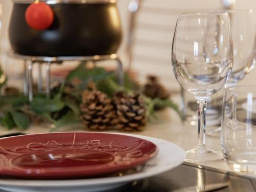 a table with a plate and a wine glass at Apartment Réze 5 by Interhome in Ovronnaz