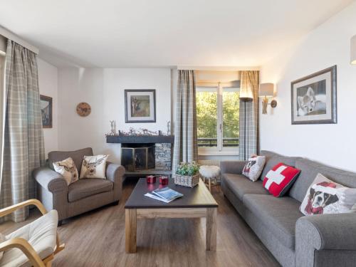 a living room with a couch and a table at Apartment Cransalpin Apt- 11 - Secteur 1 by Interhome in Vermala