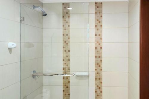 a bathroom with a shower with a glass door at EcuOlimpo Lighthouse Stay double in Guayaquil
