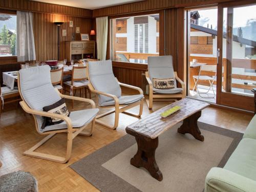 a living room with chairs and a table at Apartment Val Neige 11 by Interhome in Verbier
