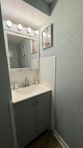 a bathroom with a sink and a mirror at Tropical Beach Studio Getaway B in Cocoa Beach